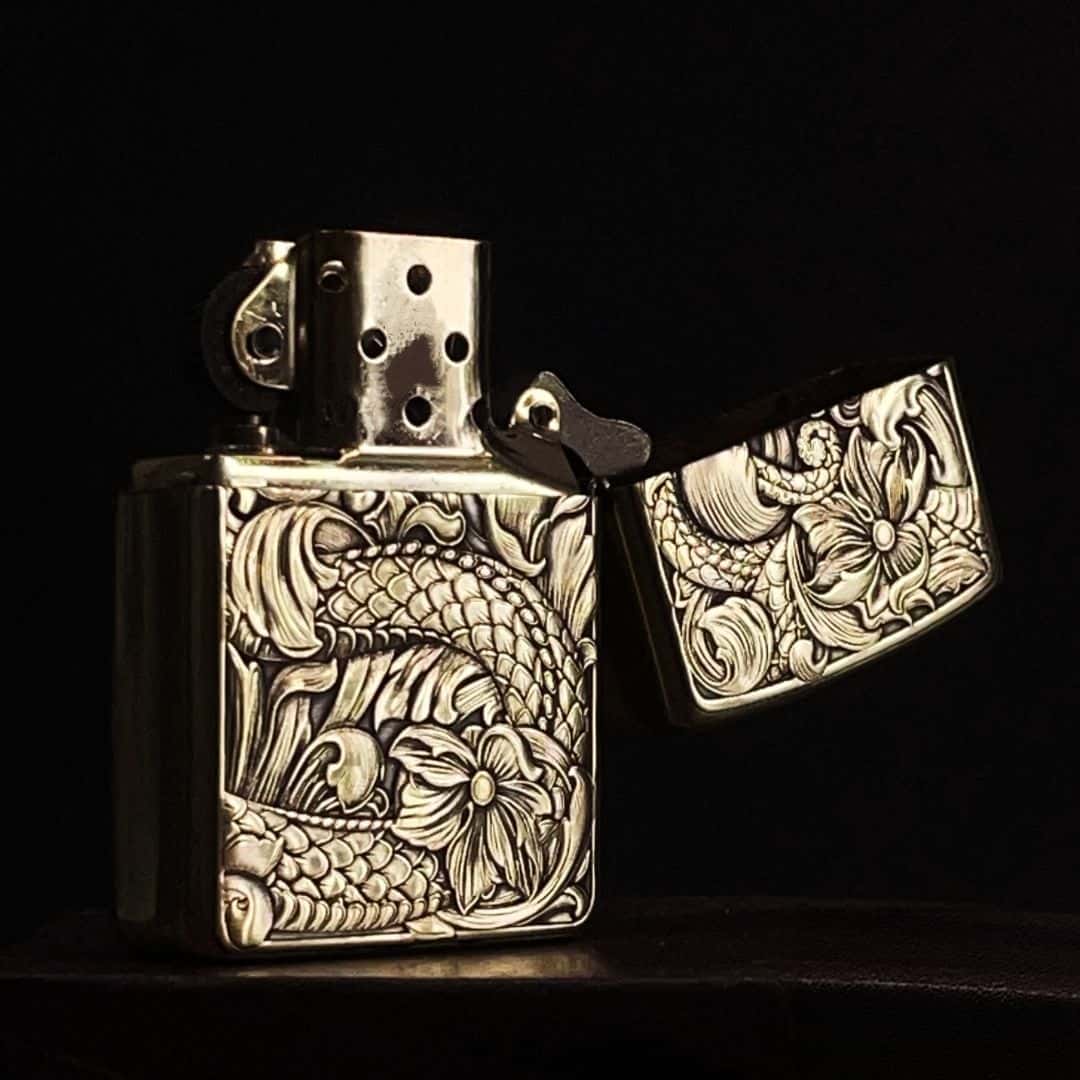 Open view showing inner mechanism of dragon lotus carved brass petrol lighter