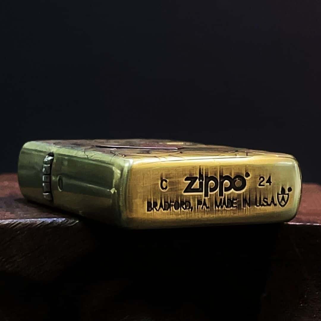Open view showing inner mechanism of Medusa carved brass petrol lighter